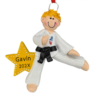Personalized karate Christmas ornament, a hand-painted martial artist in a white gi and black belt with blonde hair on a yellow star, engraved with a name and year.