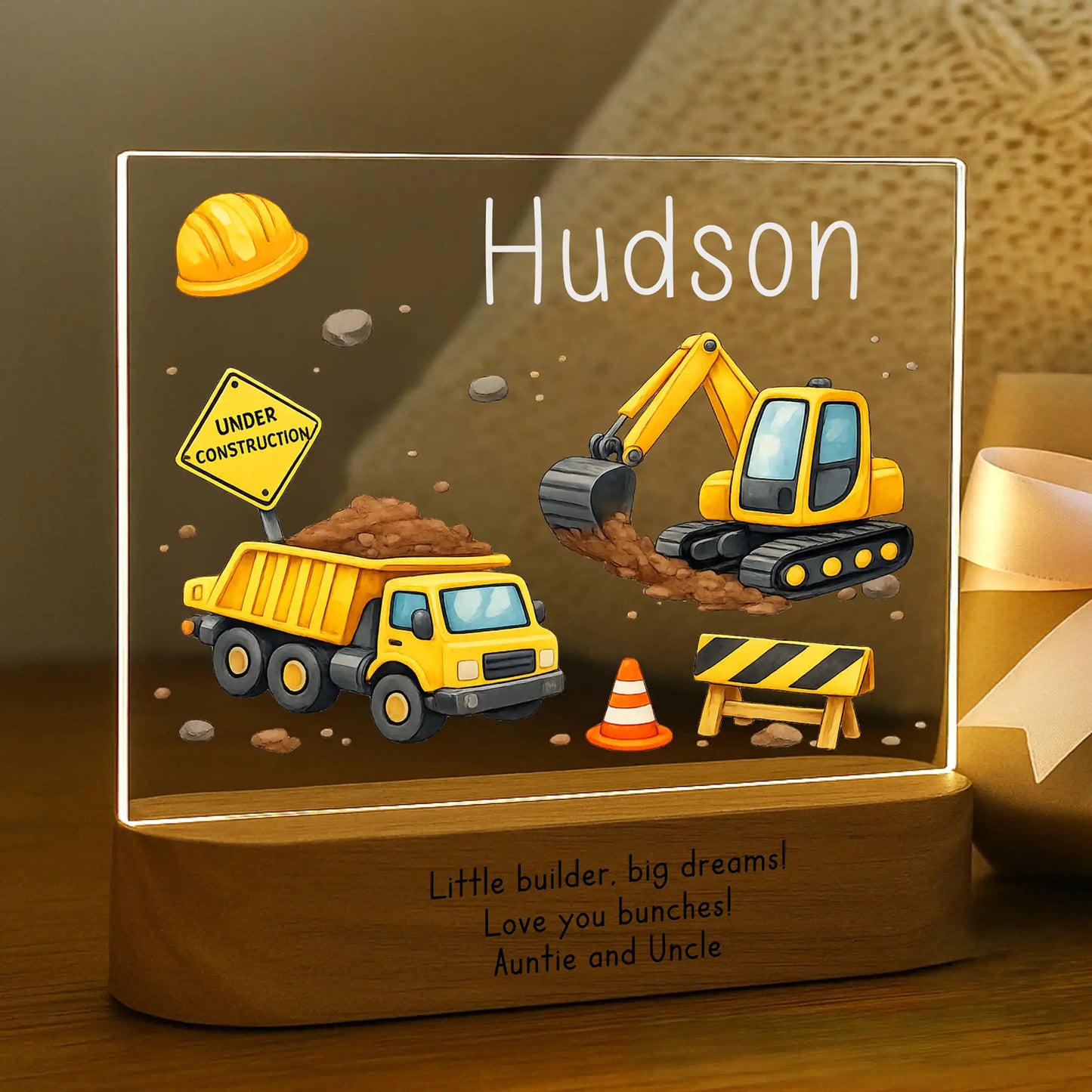 Personalized construction night light glowing with custom name Hudson on acrylic and Little Builder Big Dreams message laser engraved on acacia wood base