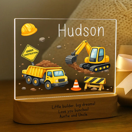 Personalized construction night light glowing with custom name Hudson on acrylic and Little Builder Big Dreams message laser engraved on acacia wood base
