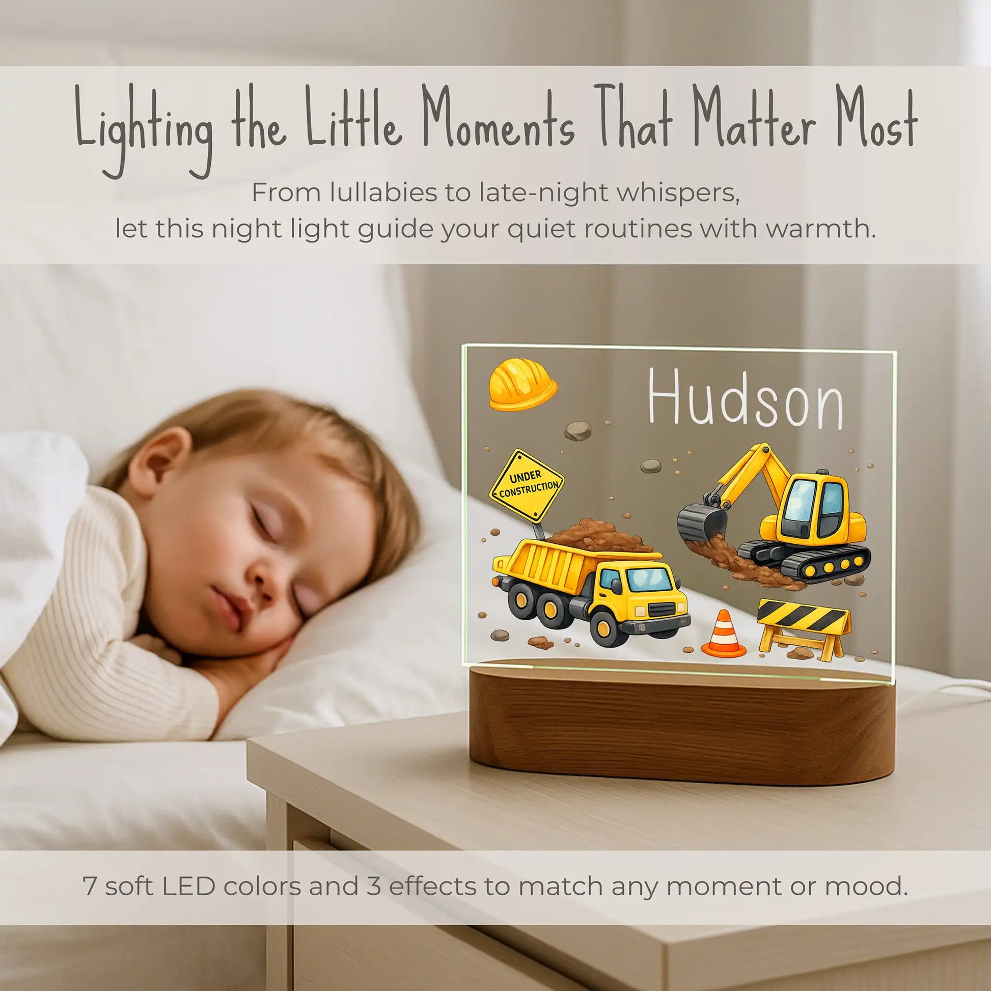 Personalized kids construction night light on nightstand beside sleeping child, 7 soft LED colors and 3 effects, custom name Hudson glowing on dump truck excavator design