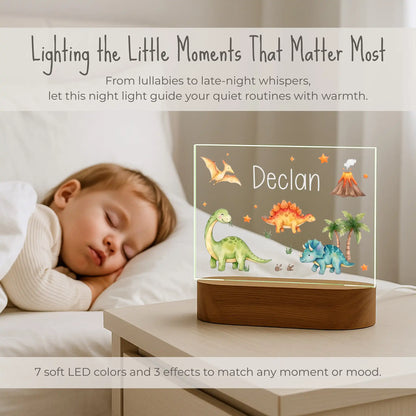 Personalized dinosaur night light lit on a nightstand beside a sleeping child with 7 LED color options
