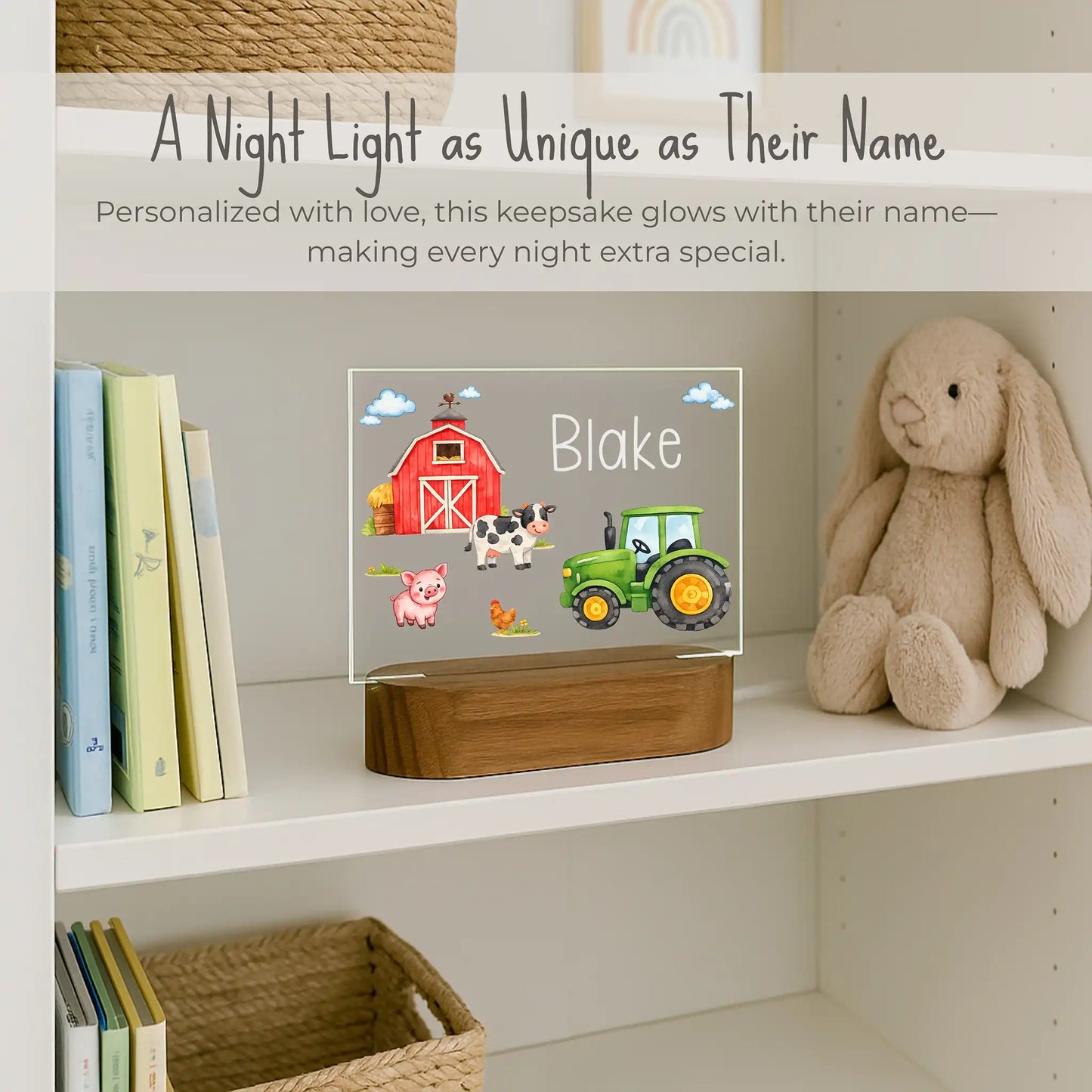 Custom name farm night light on kids bookshelf, acrylic plate with red barn green tractor cow pig and chicken design, name Blake laser engraved, warm LED glow on acacia wood base