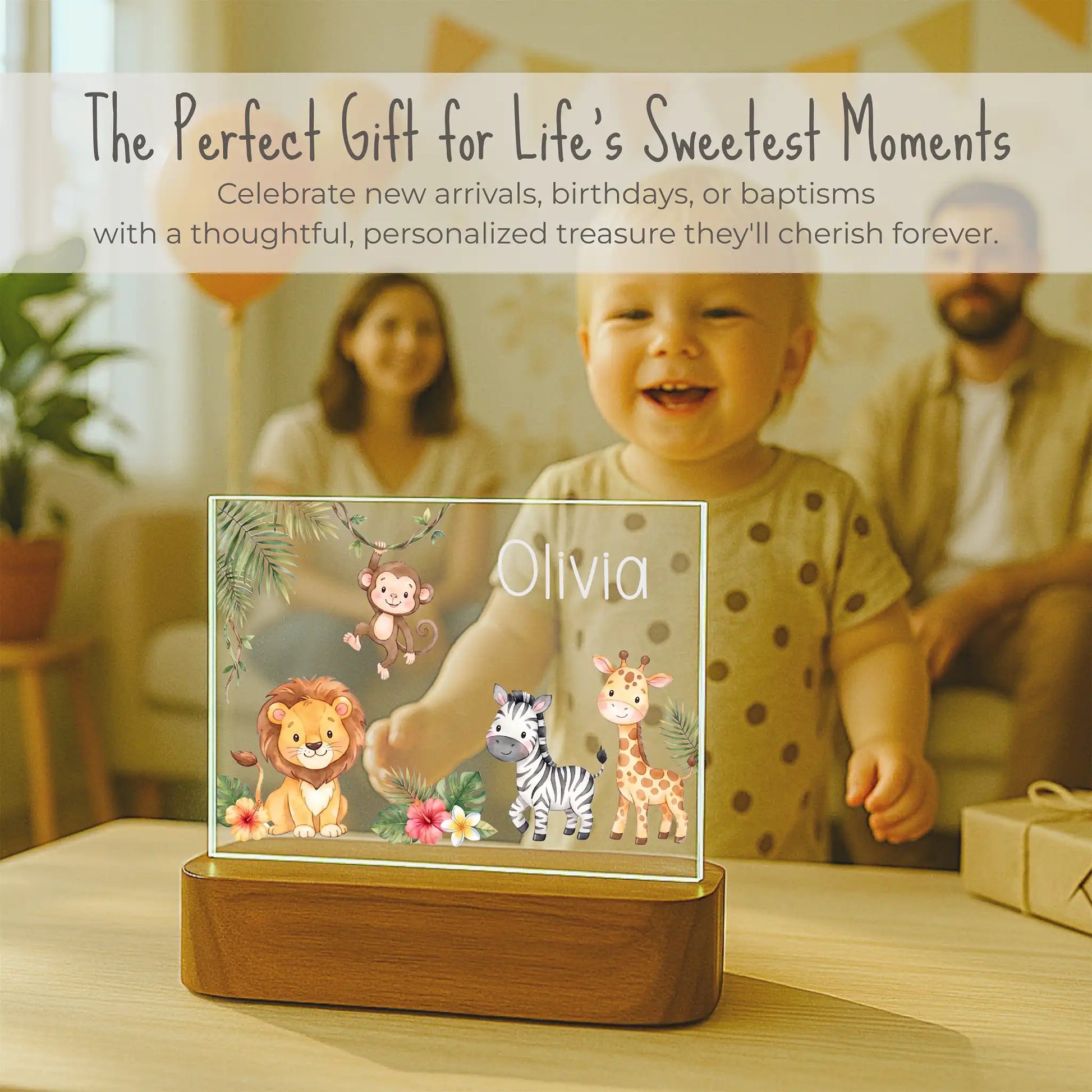 Watercolor safari design detail on personalized night light featuring lion, swinging monkey, zebra, giraffe, palm leaves, and hibiscus flowers with family in the background