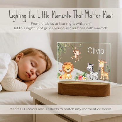 Personalized safari animals night light lit on a nightstand beside a sleeping child with 7 LED color options