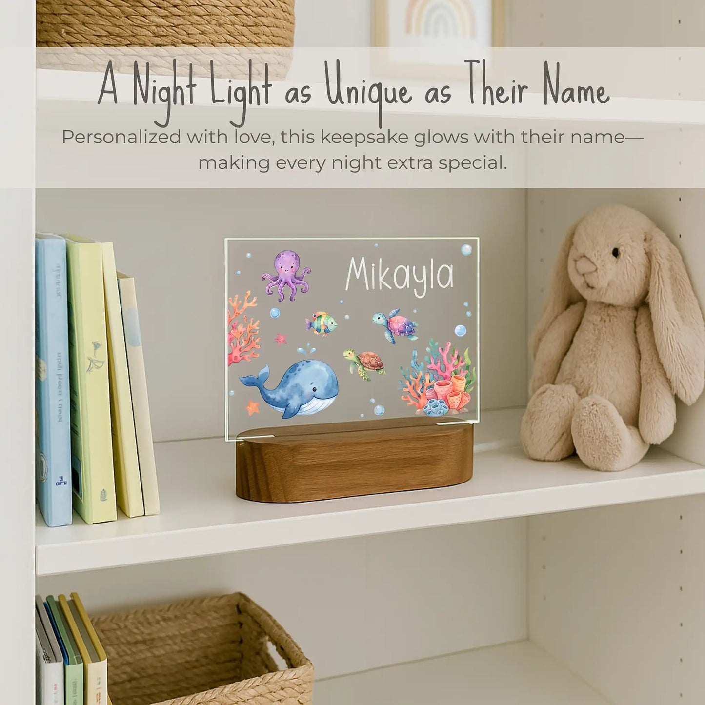Personalized ocean night light styled on a nursery bookshelf beside a stuffed bunny and children's books