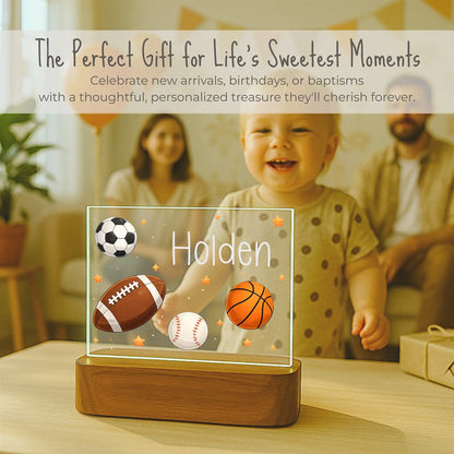 Personalized kids sports night light displayed at birthday celebration, custom name Holden on acrylic plate, gift for toddler boys who love sports, ships within 24 hours