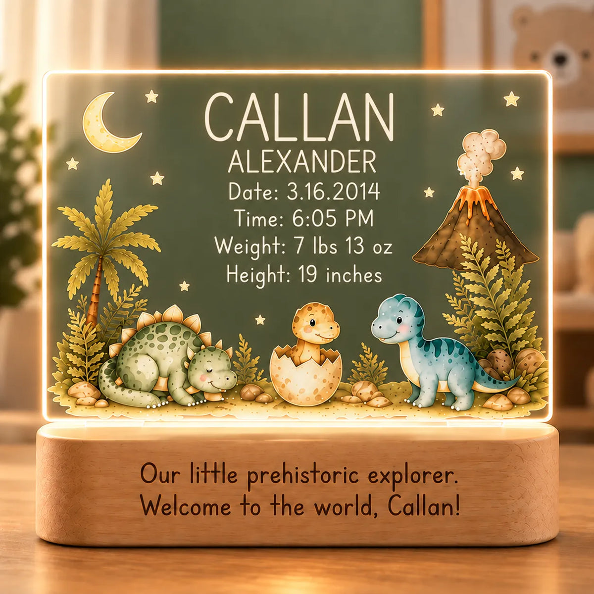 Personalized dinosaur baby night light with birth stats, baby dinosaur and volcano artwork, and engraved message on an acacia wood LED base