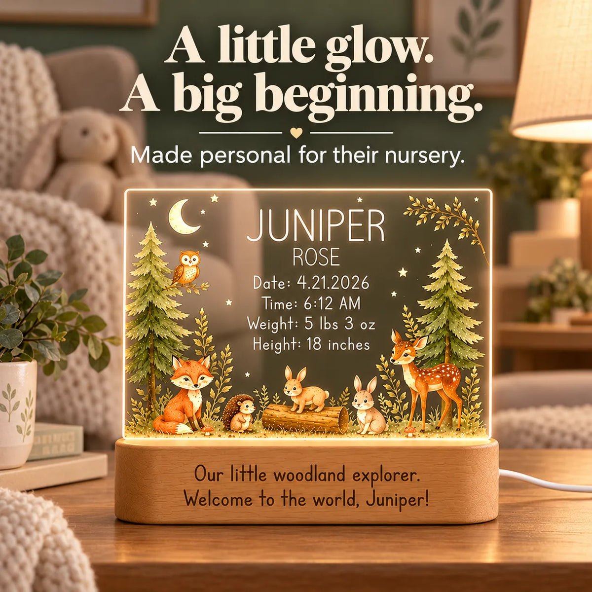 Personalized woodland birth stats night light glowing on a nursery dresser beside soft toys
