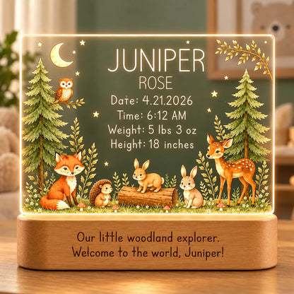 Personalized woodland baby night light with name and birth stats engraved above a fox, fawn, bunnies and hedgehog, glowing on a wood base