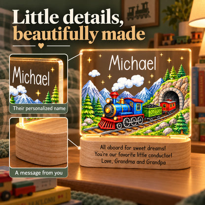 Close-up details of the personalized train night light: name on the acrylic panel and engraved wood base