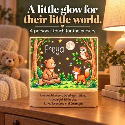 Personalized woodland bear night light glowing on a nursery dresser beside a teddy bear and soft lamp