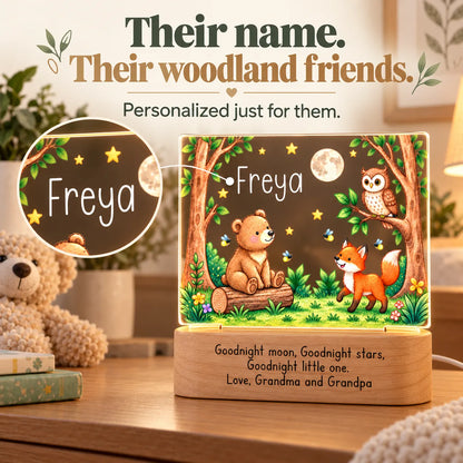 Close-up of the child's name on the personalized woodland night light above the bear cub, fox and owl