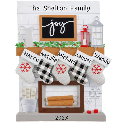 A resin fireplace mantle stocking with 'The Shelton Family' written at the top, featuring five customizable stockings with names: Harry, Natalee, Michael, Xander, and Wendy.