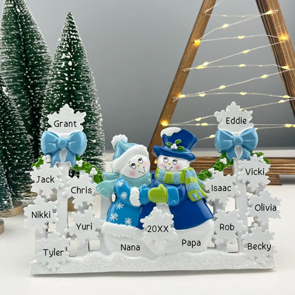 Decoración navideña de mesa azul con pareja de muñecos de nieve 
