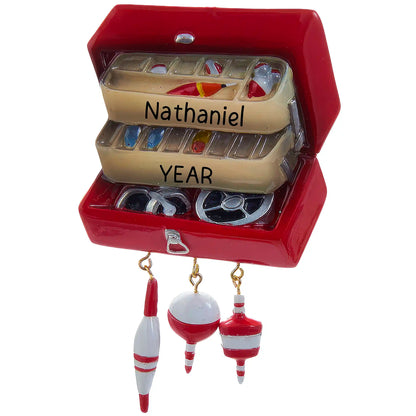 Personalized Christmas ornament shaped like an open, red fishing tackle box filled with lures, featuring three dangling red and white fishing bobbers, ready for custom engraving.