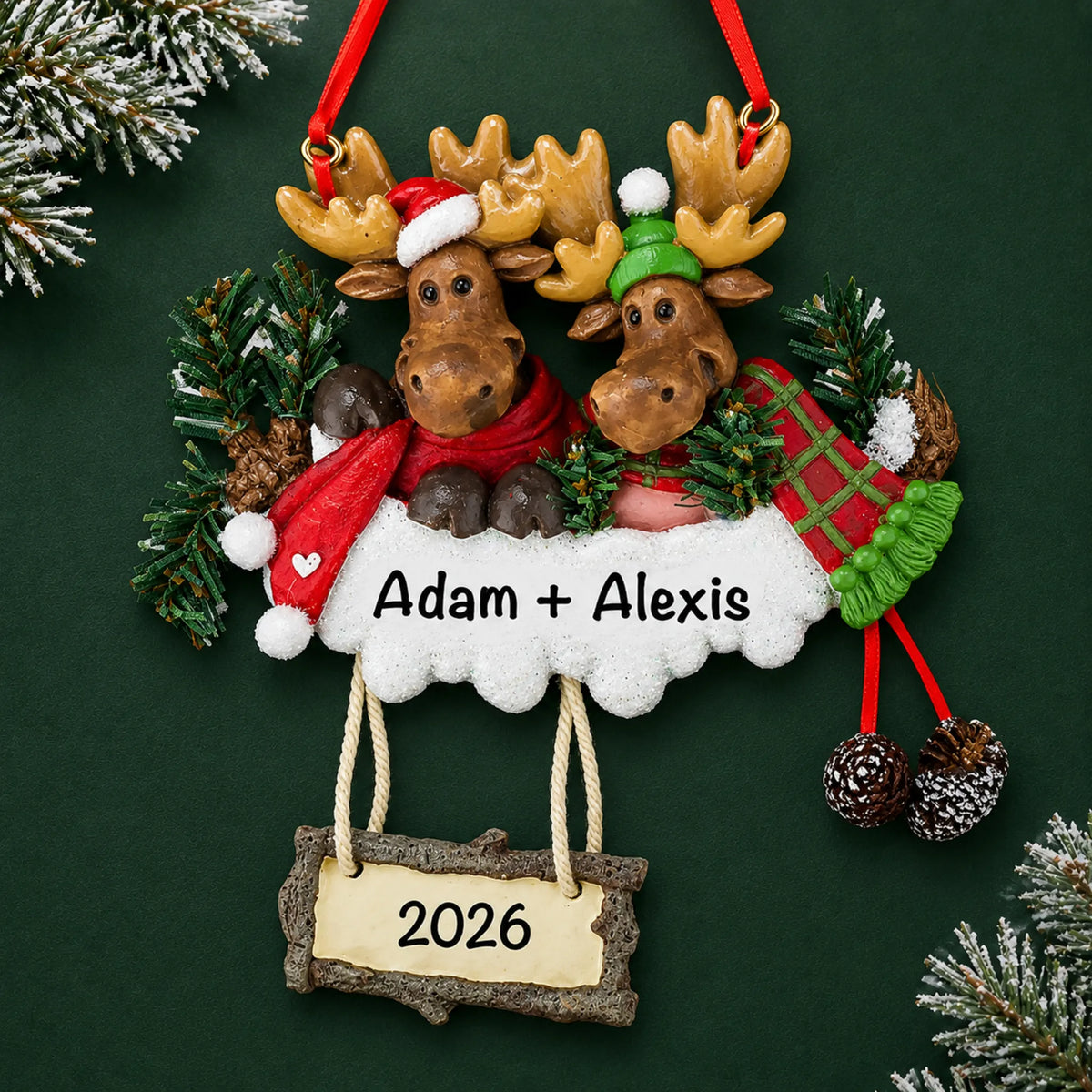 Personalized moose couple christmas ornament on a dark green pine background
