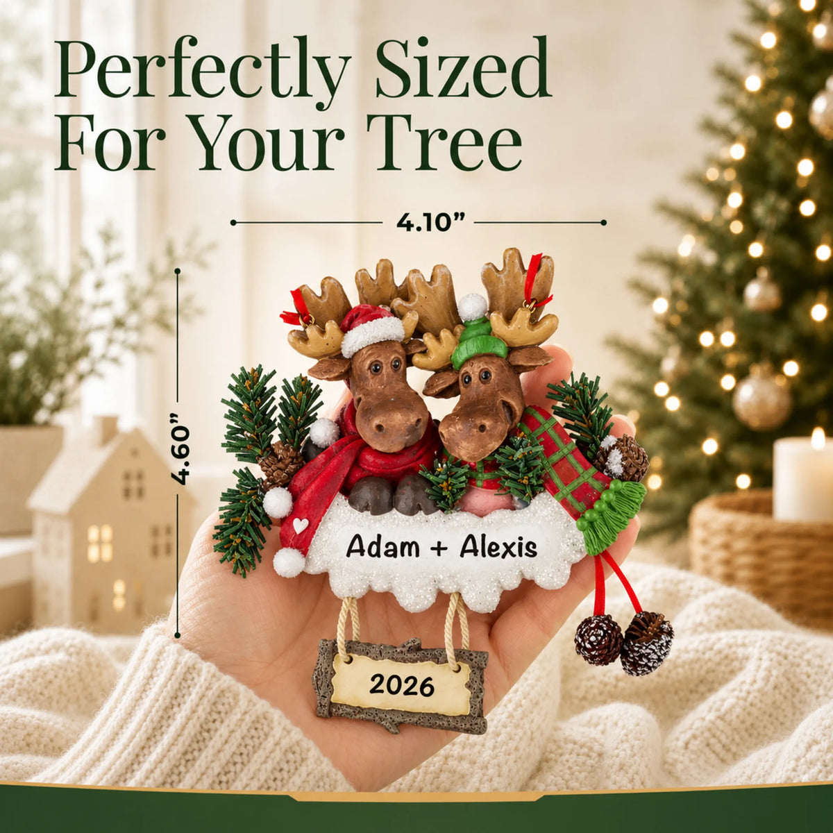 Size guide: the personalized moose couple christmas ornament is 4.10 in wide by 4.60 in tall, shown in hand