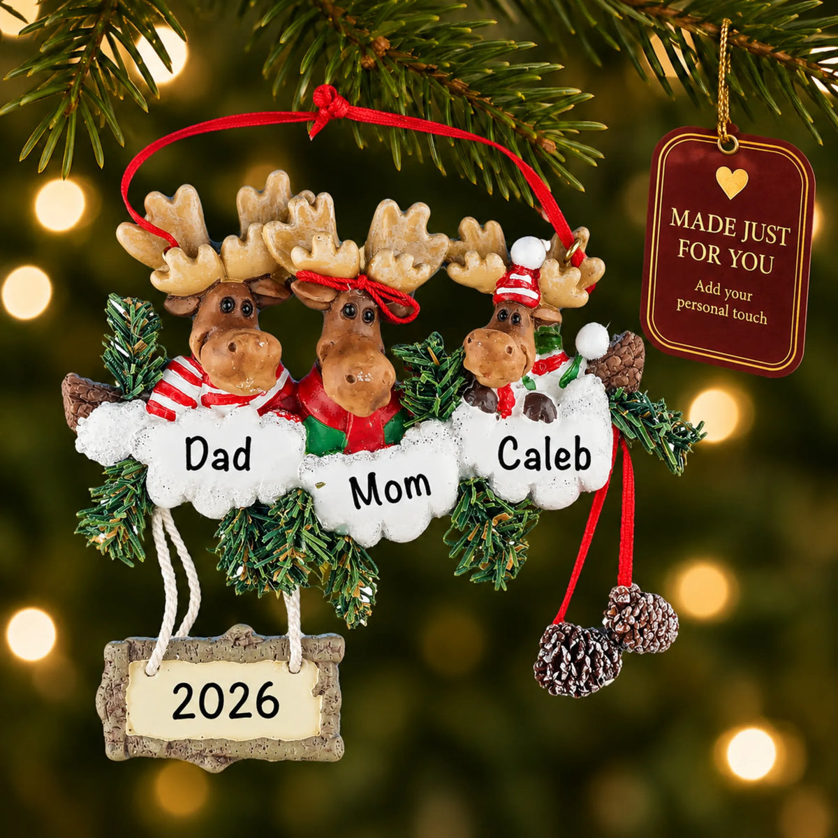 Moose family of 3 christmas ornament hanging on a lit Christmas tree with a Made Just For You gift tag