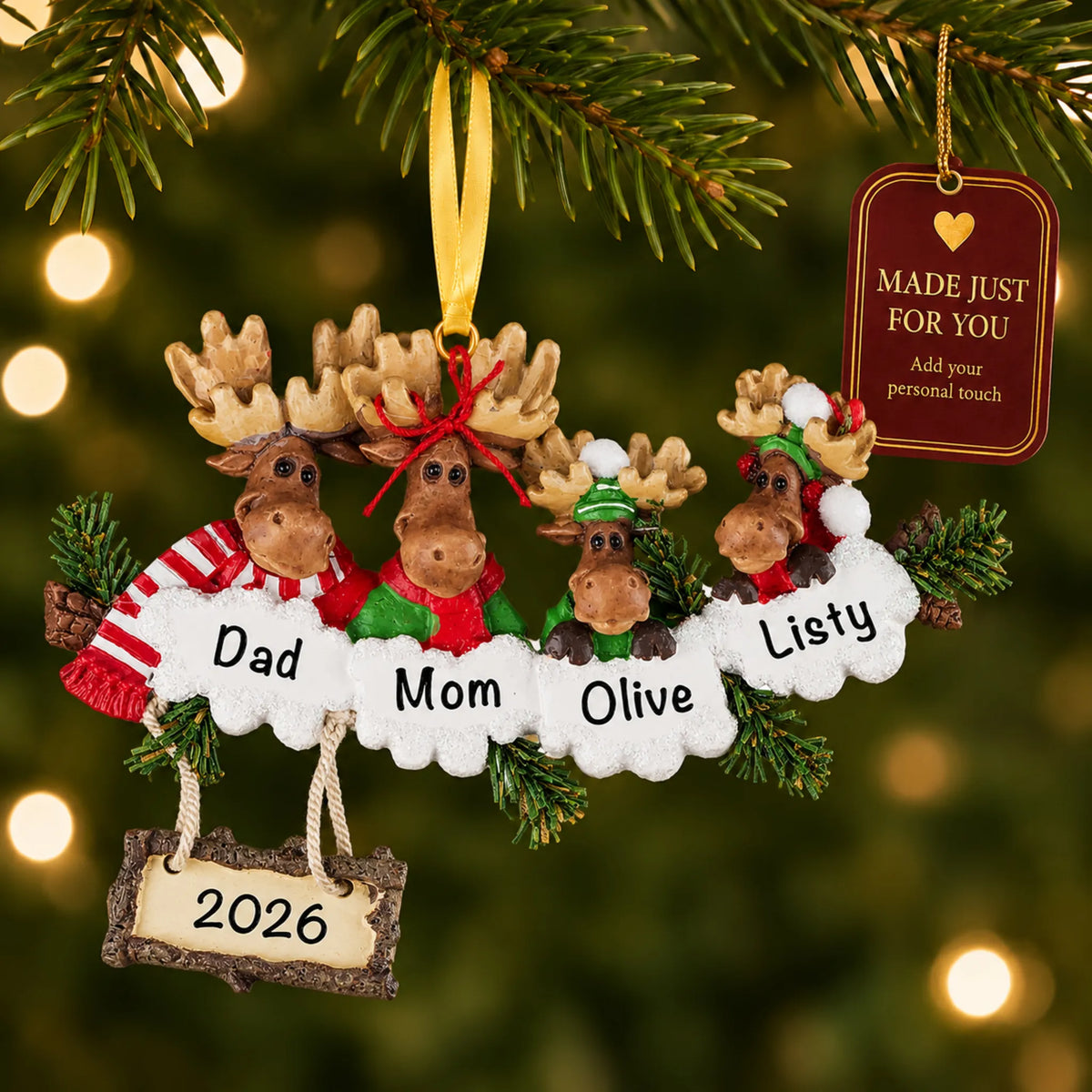Moose family of 4 christmas ornament hanging on a lit Christmas tree with a Made Just For You gift tag