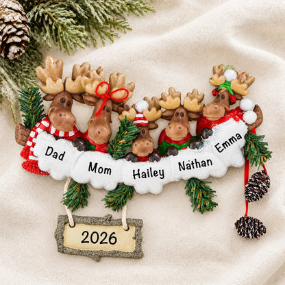 Personalized moose family of 5 christmas ornament laid on a soft white knit blanket