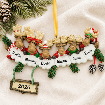 Personalized moose family of 6 christmas ornament laid on a soft white knit blanket