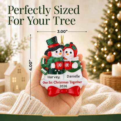 Size guide: the personalized snowman couple our 1st christmas together ornament shown in hand next to a Christmas tree