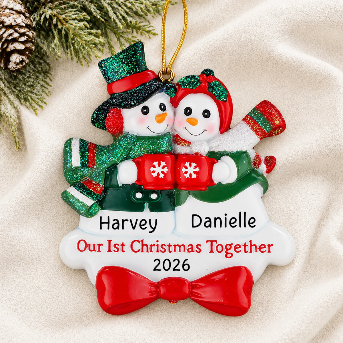 Personalized snowman couple our 1st christmas together ornament laid on a soft white knit blanket
