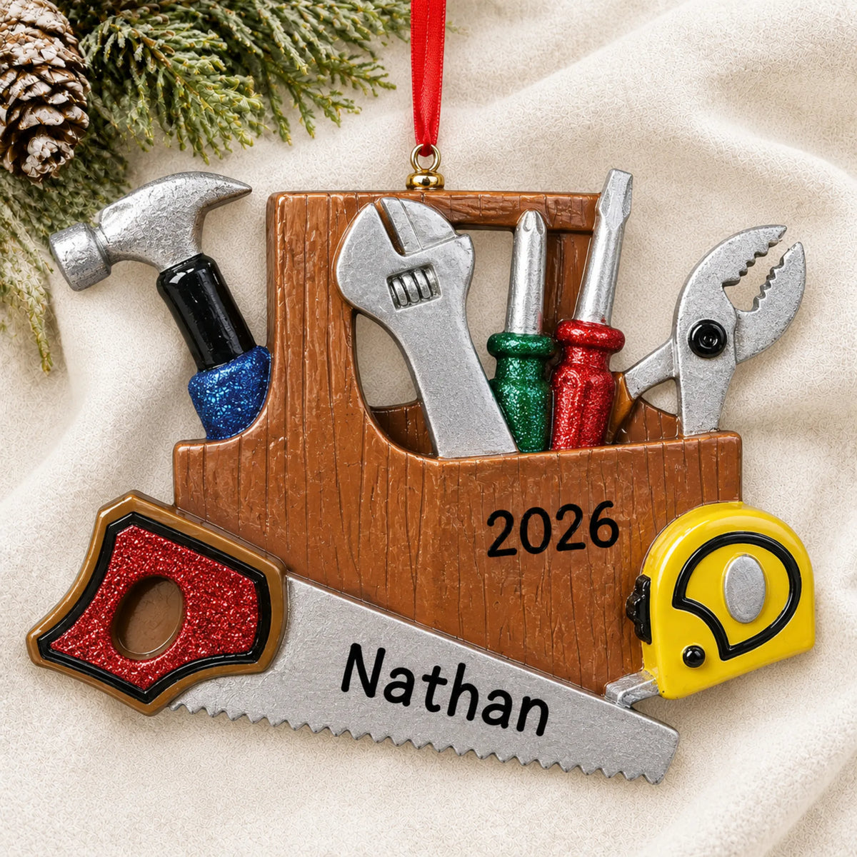 Personalized handyman christmas ornament laid on a soft white knit blanket