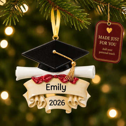 Personalized graduation cap and scroll Christmas ornament on a lit tree with a made-just-for-you personalization tag