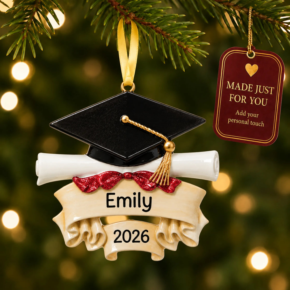 Personalized graduation cap and scroll Christmas ornament on a lit tree with a made-just-for-you personalization tag