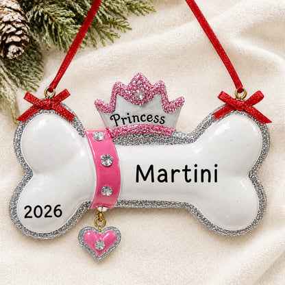 Personalized Princess Dog Bone christmas ornament laid on a soft white knit blanket