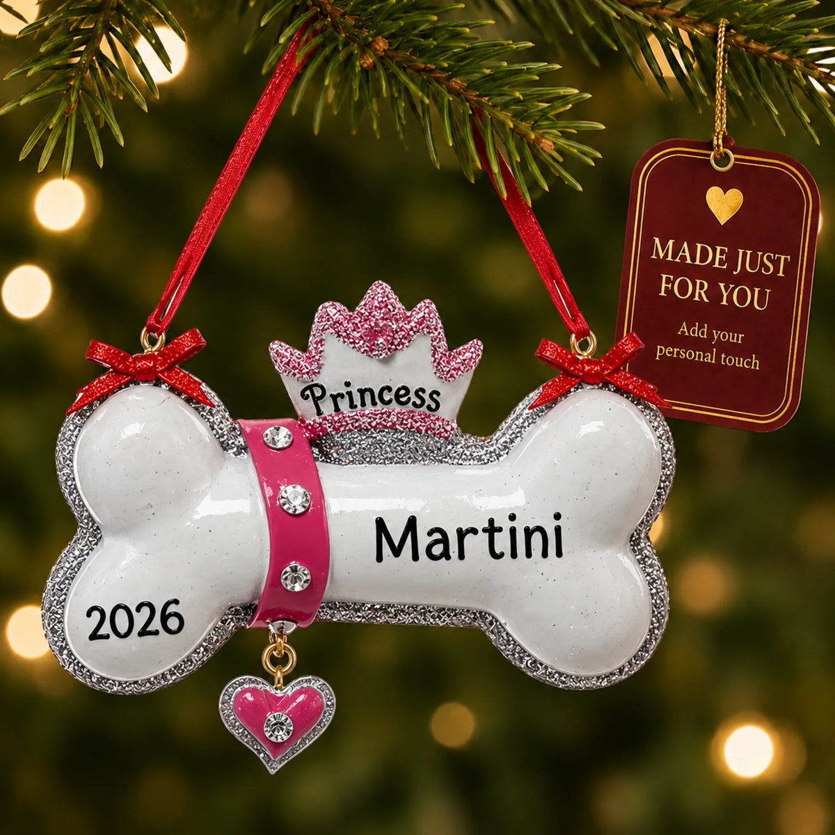 Princess Dog Bone christmas ornament hanging on a lit Christmas tree with a Made Just For You gift tag
