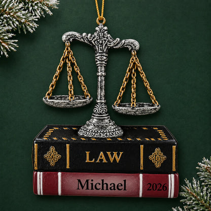 Personalized legal scales of justice christmas ornament on a dark green pine background