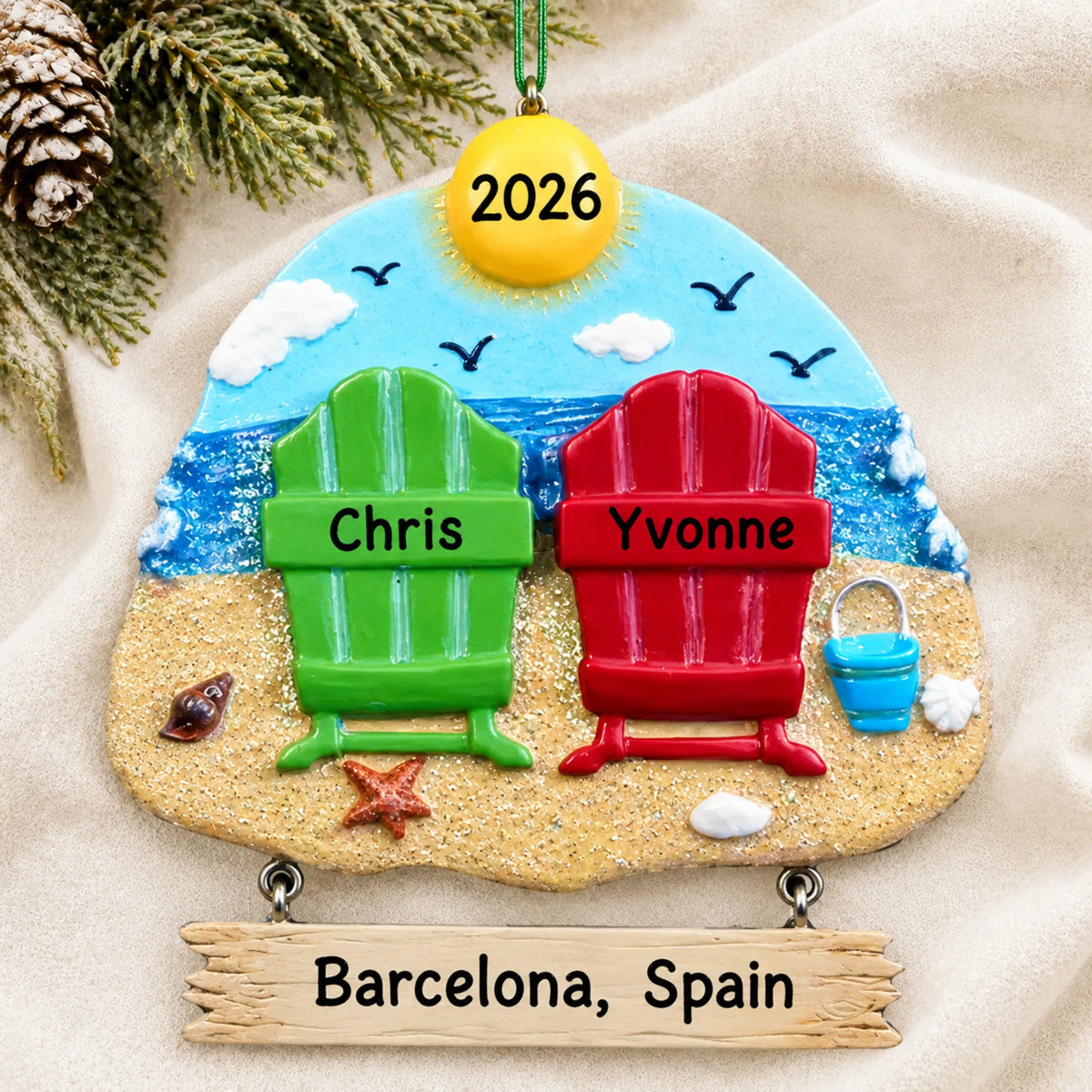 Personalized beach chair couple christmas ornament laid on a soft white knit blanket