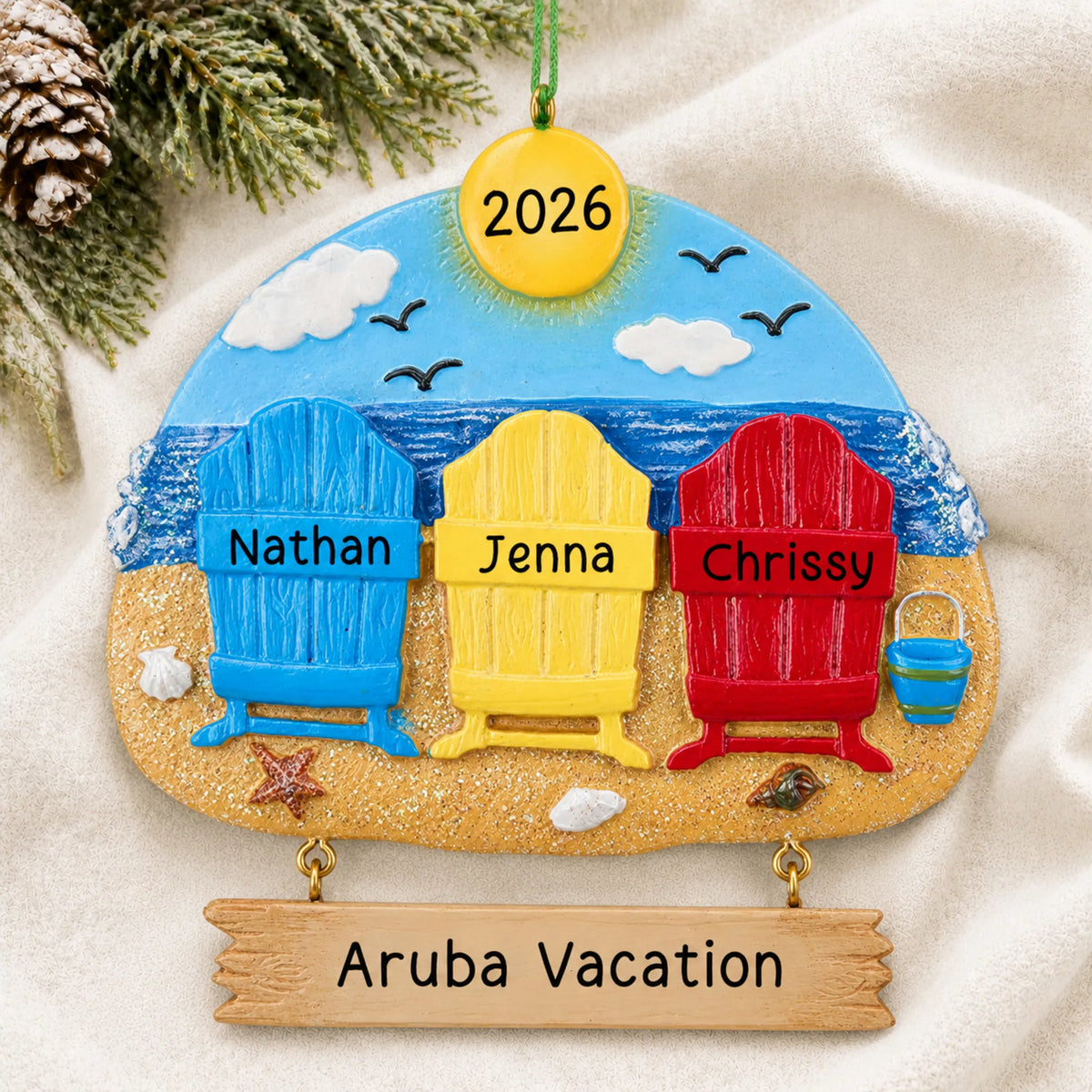 Personalized beach family of 3 christmas ornament laid on a soft white knit blanket