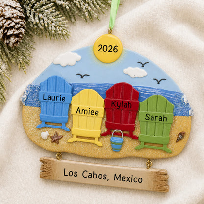 Personalized beach family of 4 christmas ornament laid on a soft white knit blanket