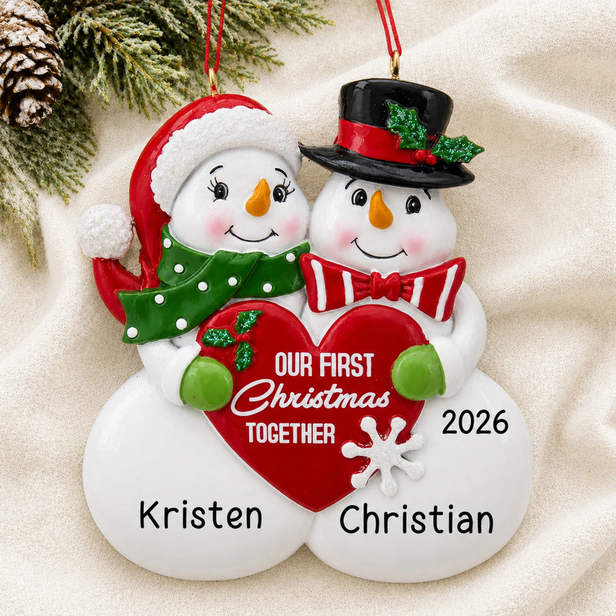 Personalized our 1st christmas together ornament laid on a soft white knit blanket