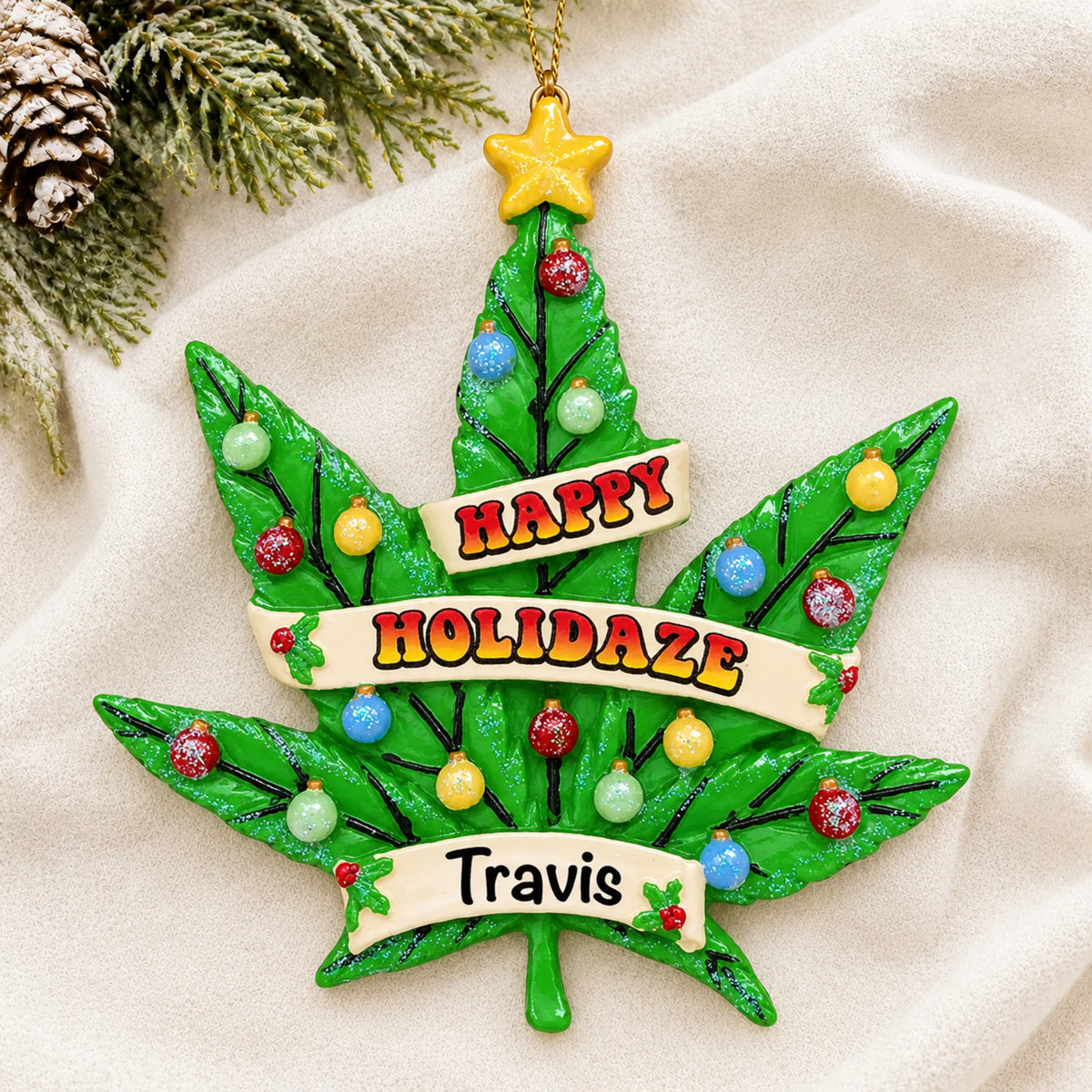 Personalized cannabis leaf holiday tree christmas ornament laid on a soft white knit blanket