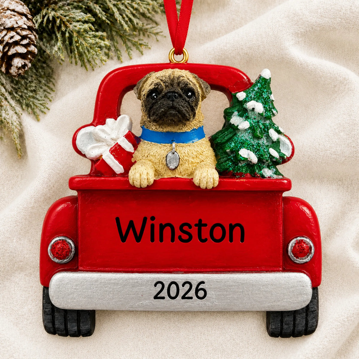 Personalized Pug Vintage Truck christmas ornament laid on a soft white knit blanket