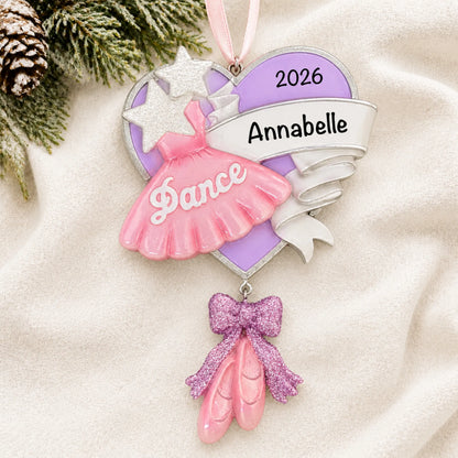 Personalized ballet dance christmas ornament laid on a soft white knit blanket