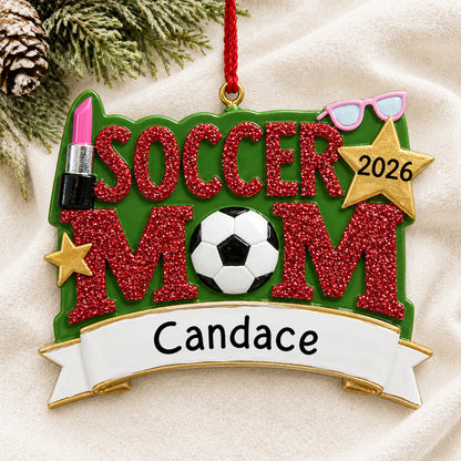 Personalized soccer mom christmas ornament laid on a soft white knit blanket
