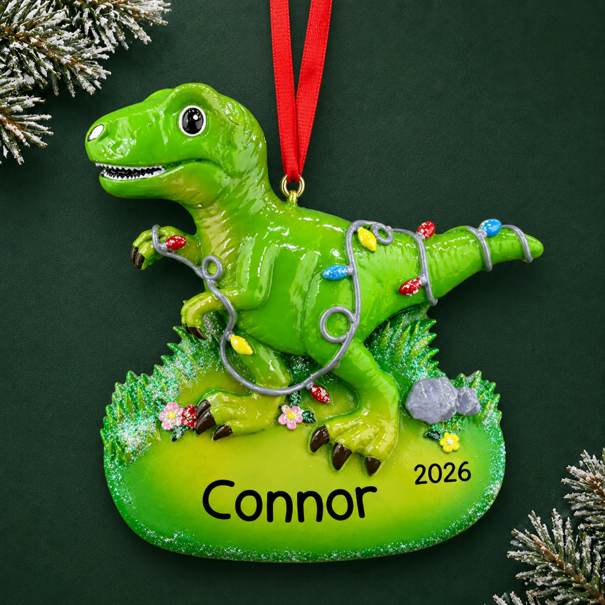 Personalized christmas lights t-rex dinosaur ornament on a dark green pine background