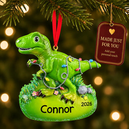 Christmas lights t-rex dinosaur ornament hanging on a lit Christmas tree with a Made Just For You gift tag