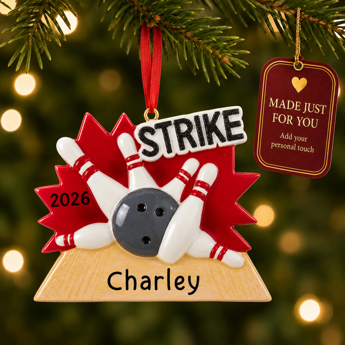 Bowling strike christmas ornament hanging on a lit Christmas tree with a Made Just For You gift tag