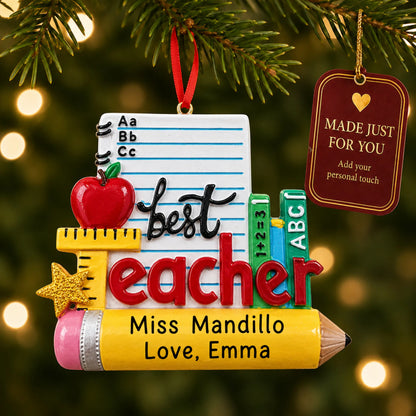 Personalized best teacher stationery Christmas ornament hanging among tree lights with a Made Just For You tag
