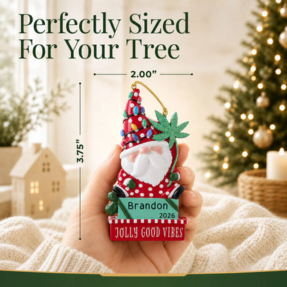 Size guide: the personalized cannabis santa gnome christmas ornament is 2.00 in wide by 3.75 in tall, shown in hand