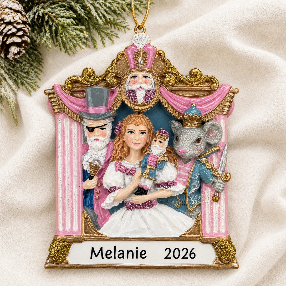 Personalized Nutcracker Suite christmas ornament laid on a soft white knit blanket
