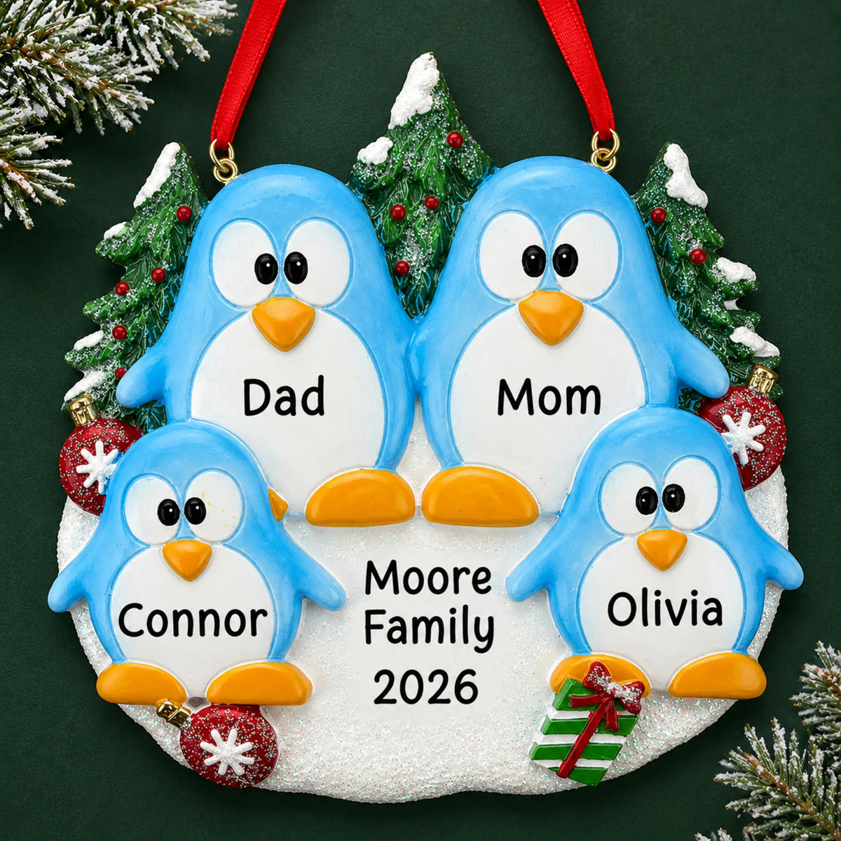Personalized penguin family of 4 christmas ornament on a dark green pine background