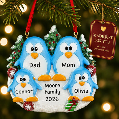 Penguin family of 4 christmas ornament hanging on a lit Christmas tree with a Made Just For You gift tag