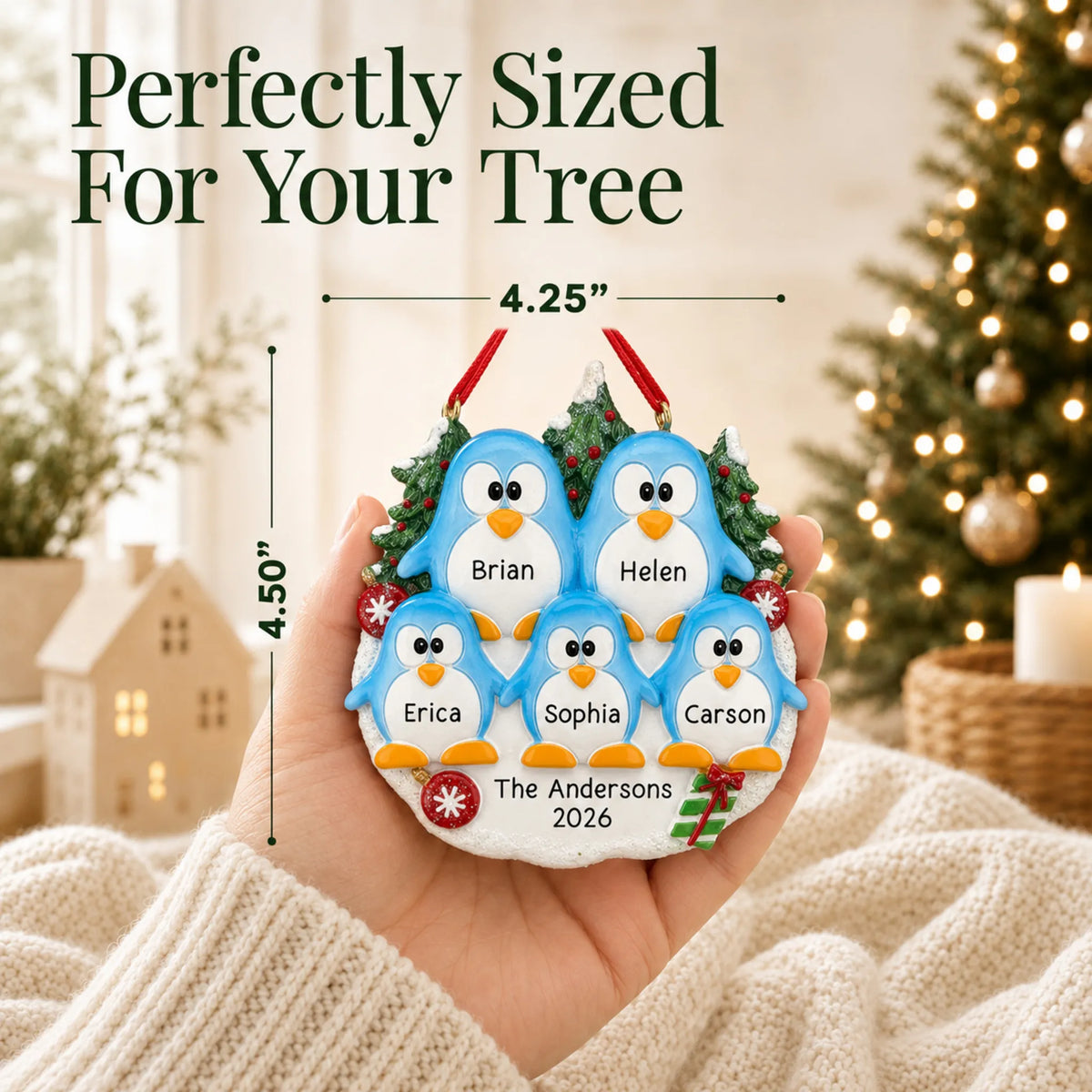 Size guide: the personalized penguin family of 5 christmas ornament is 4.25 in wide by 4.50 in tall, shown in hand
